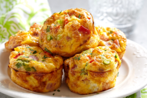 Savory breakfast muffins loaded with eggs, cheese, and veggies, served hot and ready to enjoy.