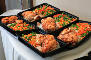 Prepared meal prep containers with seasoned chicken, rice, and mixed vegetables ready for the week ahead.