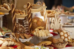 A lavish display of assorted breads and baked goods presented in an inviting bakery setup.