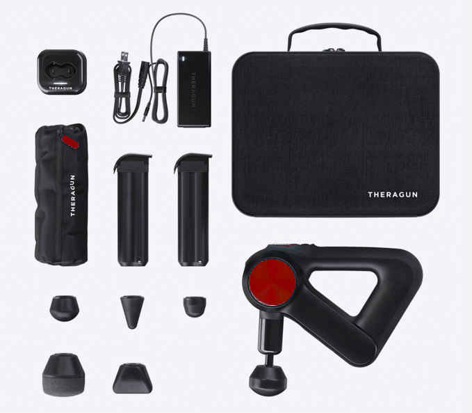 A collection of massage therapy equipment featuring a portable, handheld percussive therapy device (theragun) with various interchangeable heads, a battery, a charger, and a carrying case.