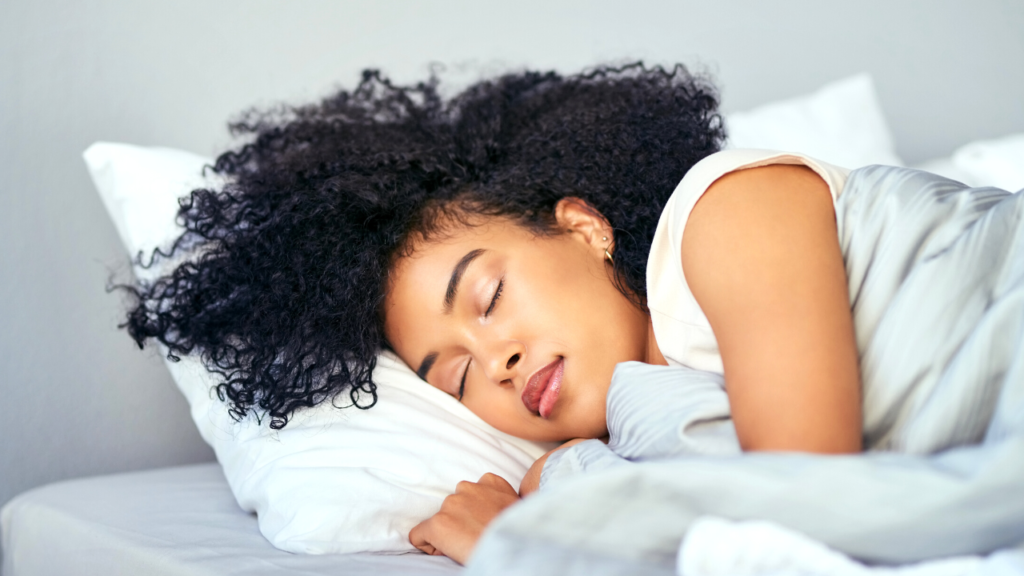 Peaceful slumber: a woman enjoys a restful sleep, embracing the comfort of her pillow and the tranquility of her surroundings.