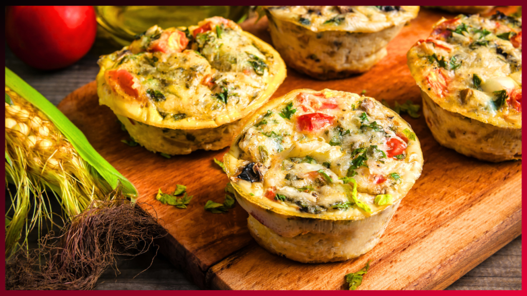 Savory vegetable-packed egg muffins served on a wooden cutting board, a delicious and healthy choice for breakfast or a quick snack.