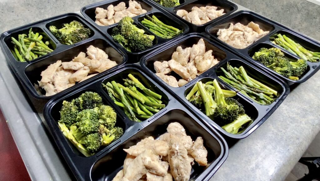 Meal prep done right: a week's worth of healthy, portion-controlled lunches with grilled chicken, fresh broccoli, and green beans, ready to go.