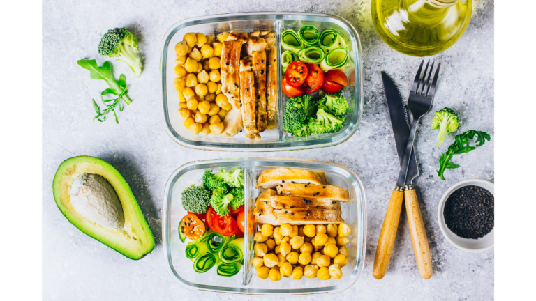 A well-organized meal prep layout with grilled chicken, chickpeas, and assorted fresh vegetables, accompanied by olive oil and chia seeds, showcasing a healthy and balanced diet.