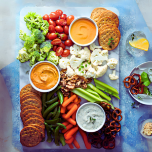 A colorful array of fresh vegetables and dip, accompanied by cookies and a side salad, arranged neatly for a healthy and appetizing 15 Plant-Based Recipes - eBook platter.