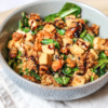 A bowl of wholesome vegan recipes - eBook salad with tofu, spinach, and a savory dressing, perfect for a nutritious and tasty meal.