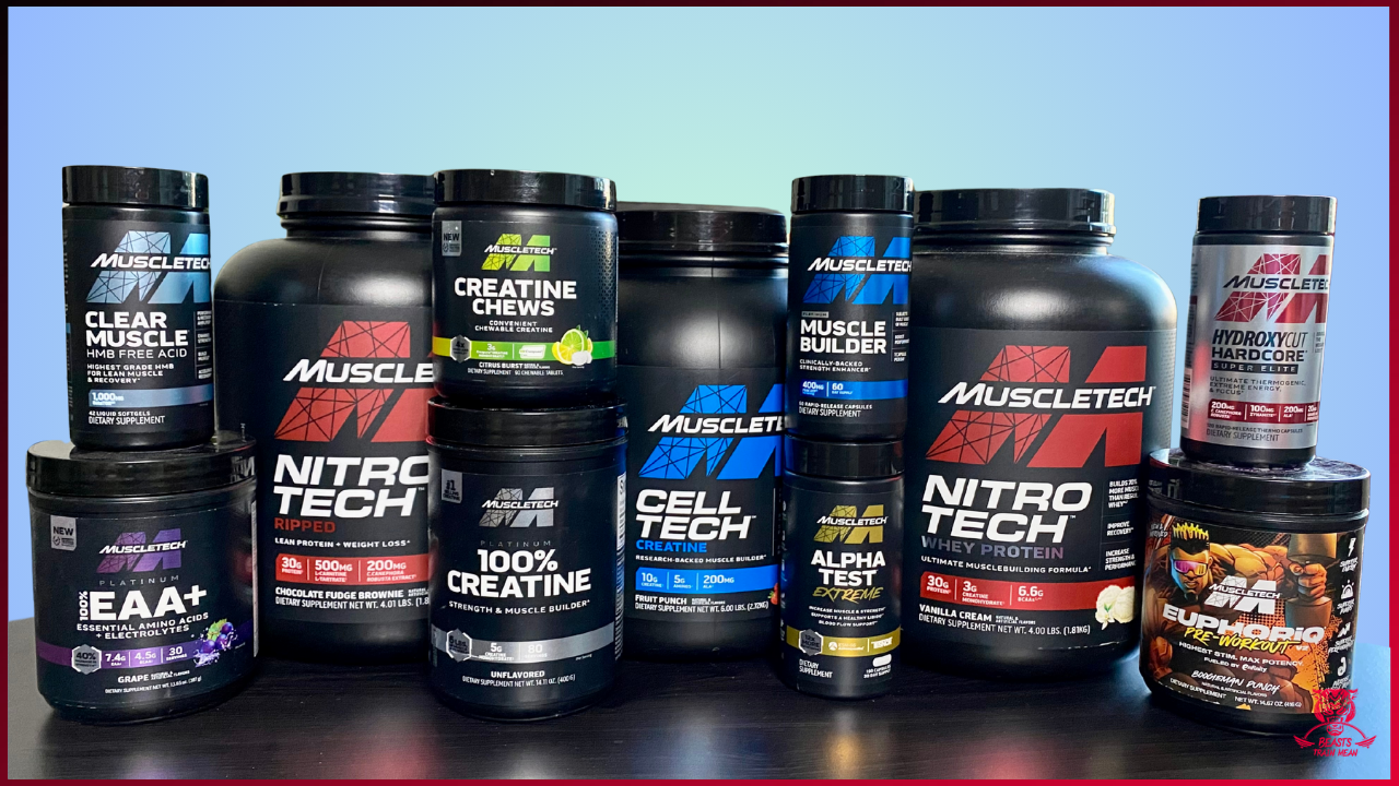 A collection of various MuscleTech supplement containers, including whey protein, creatine, amino acids, and pre-workout powders, arranged on a black surface against a blue gradient background.